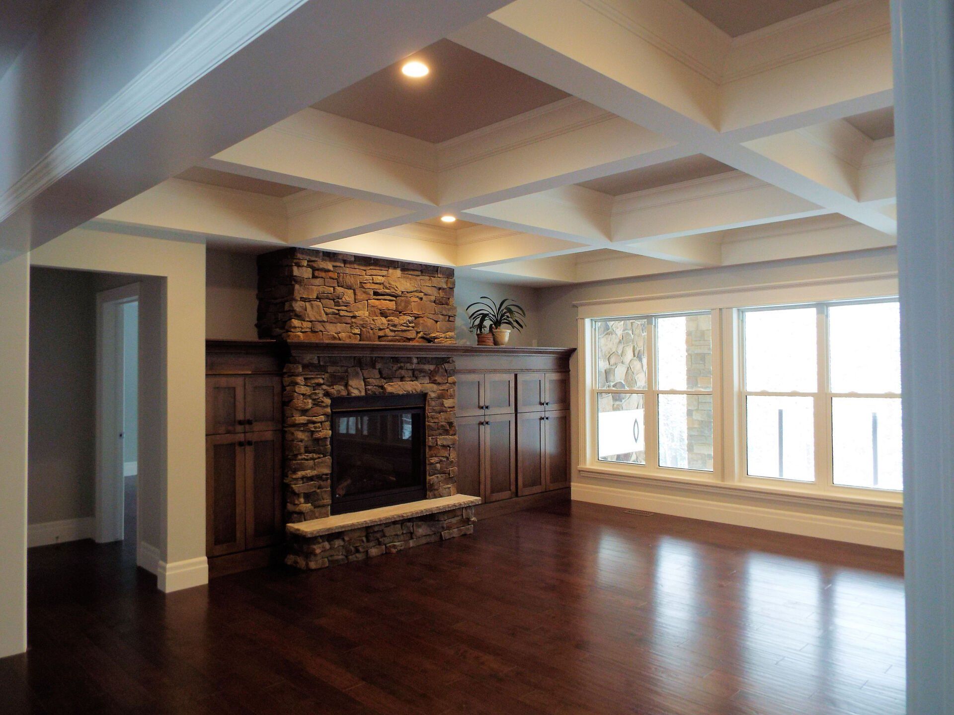 A living room with a fireplace and lots of windows