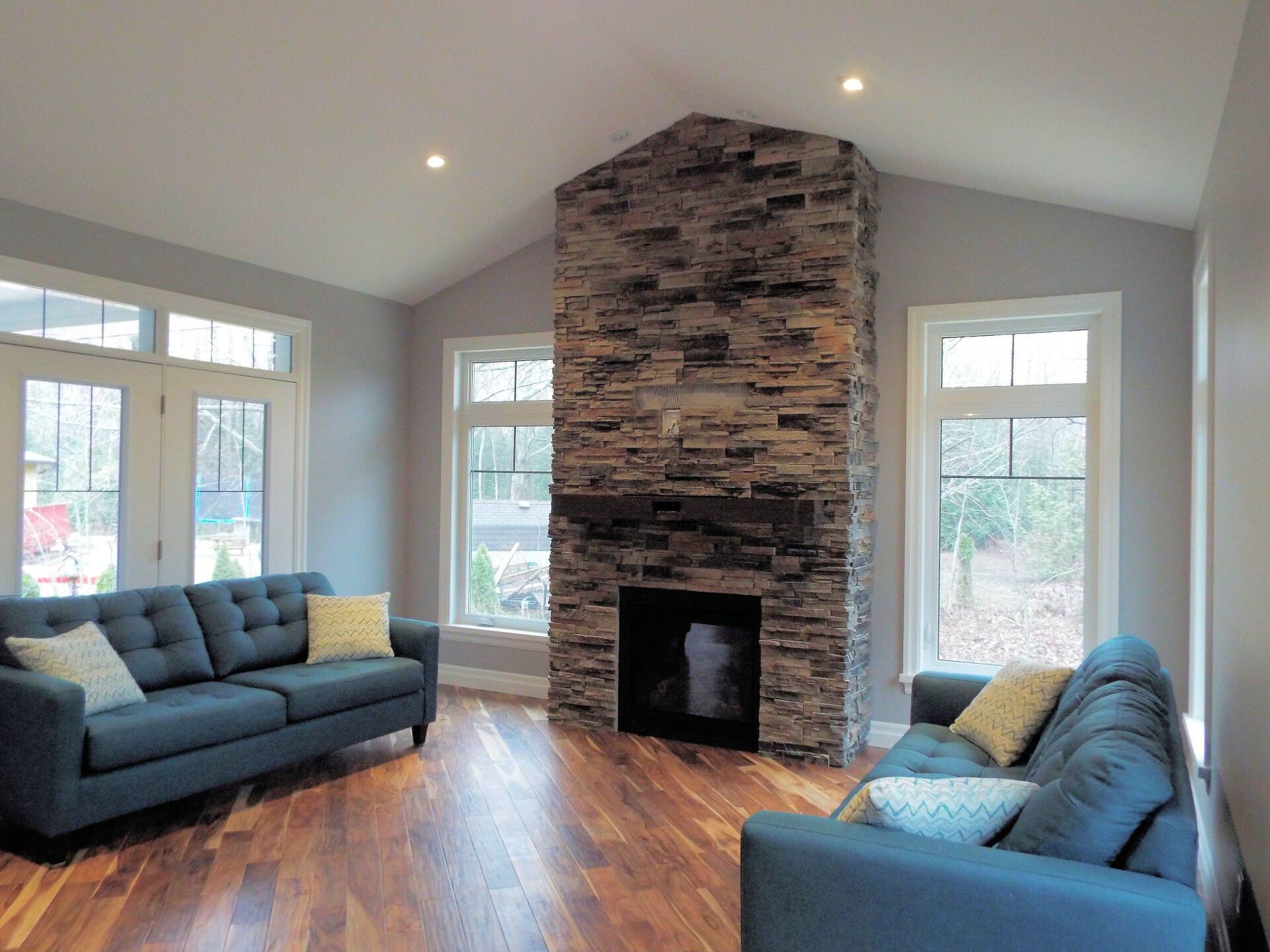A living room with two couches and a fireplace.