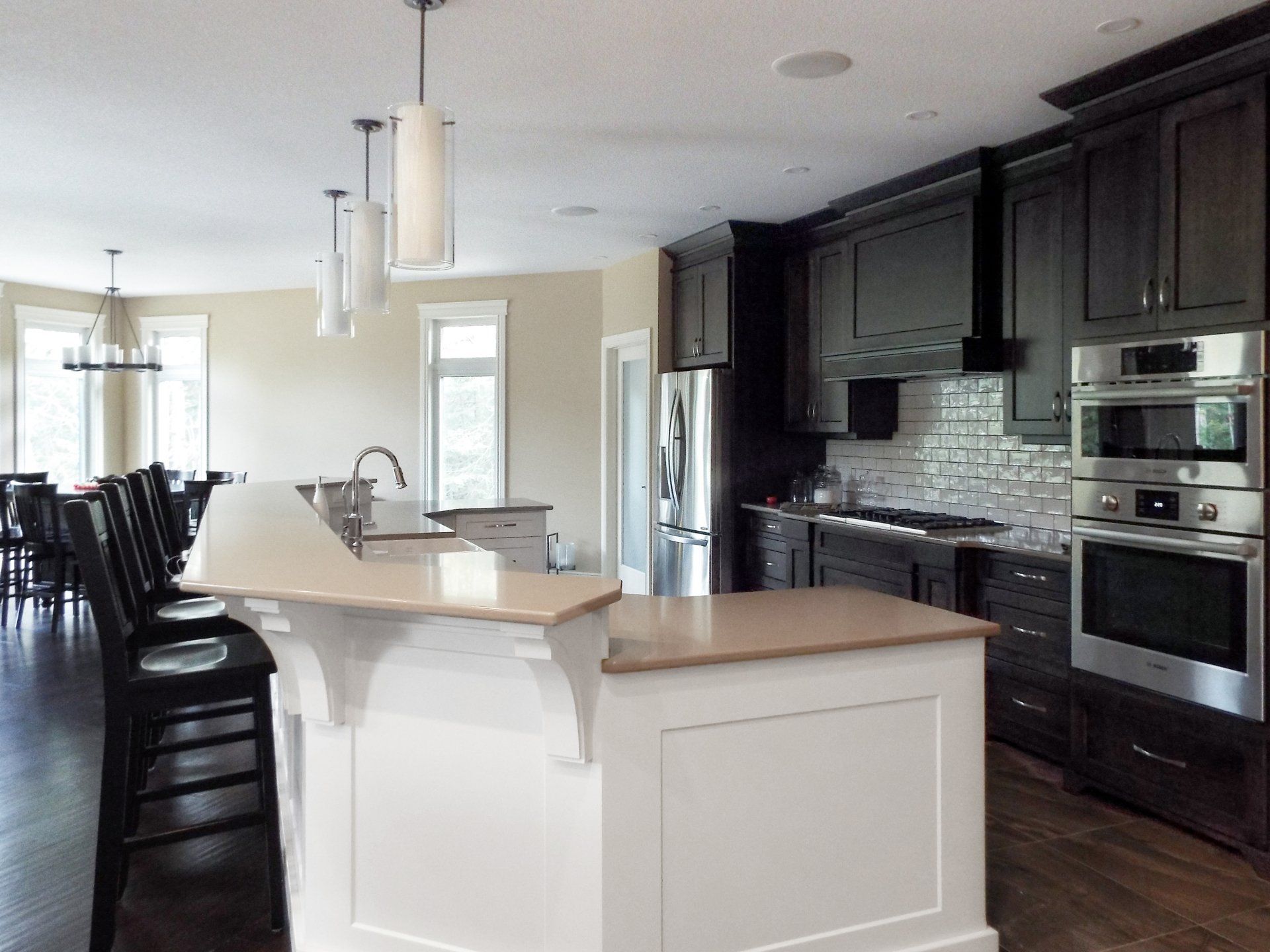 A kitchen with black cabinets and stainless steel appliances