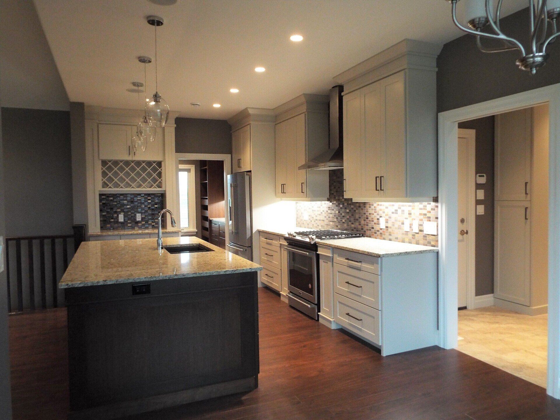 An empty kitchen with a large island in the middle