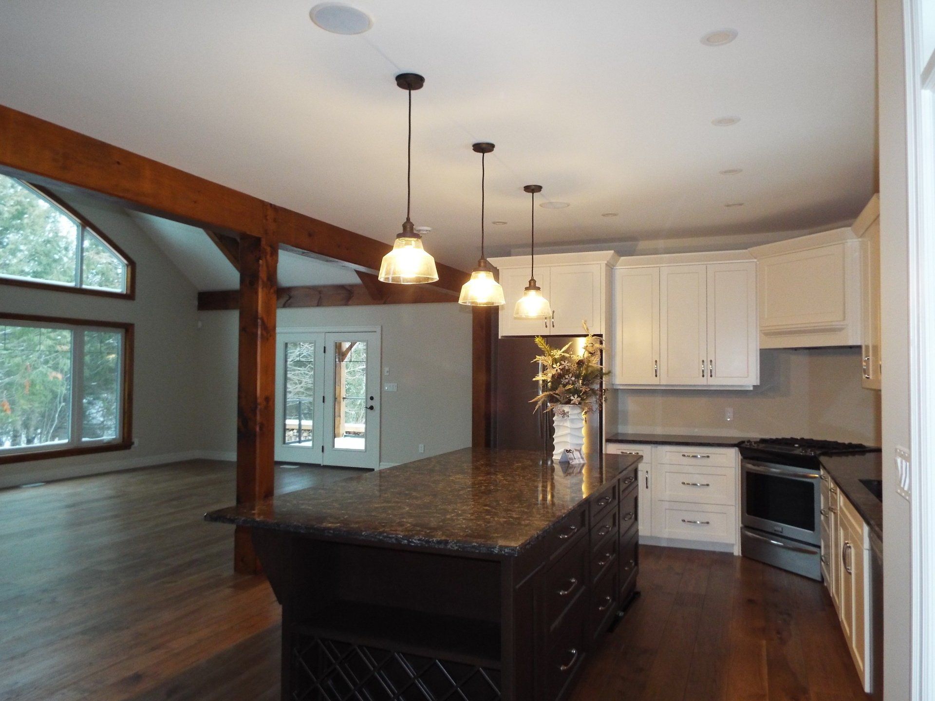 An empty kitchen with a large island in the middle