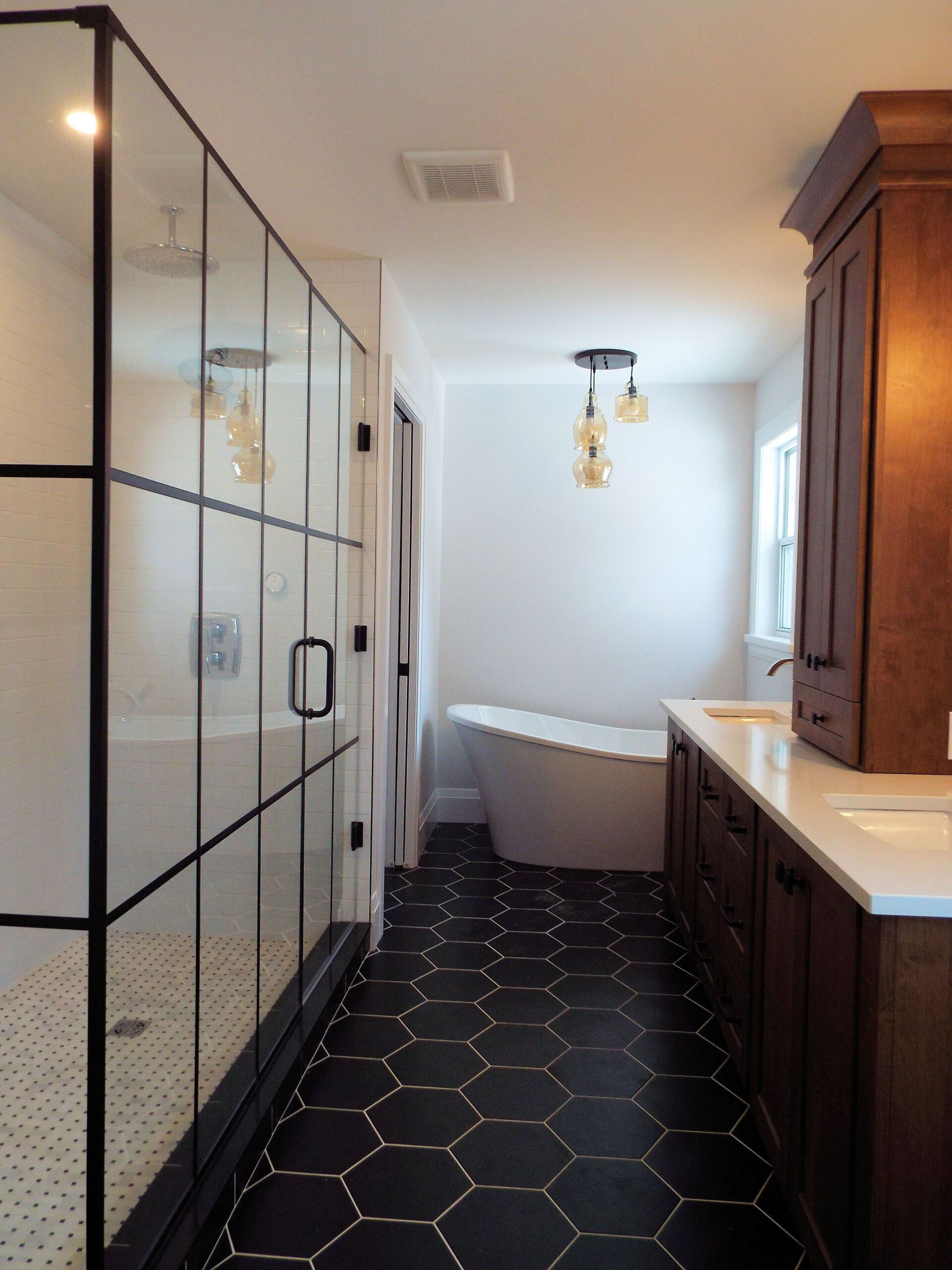 A bathroom with a tub and a walk in shower