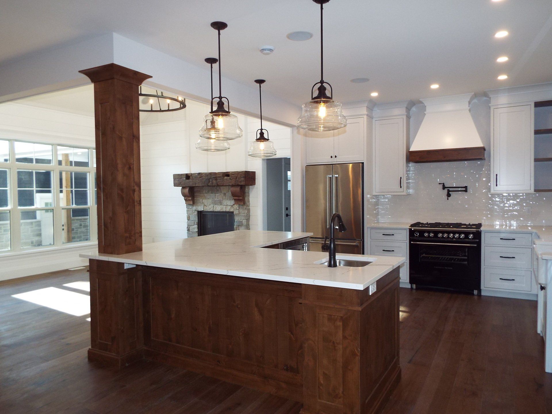 A kitchen with a large island and white cabinets