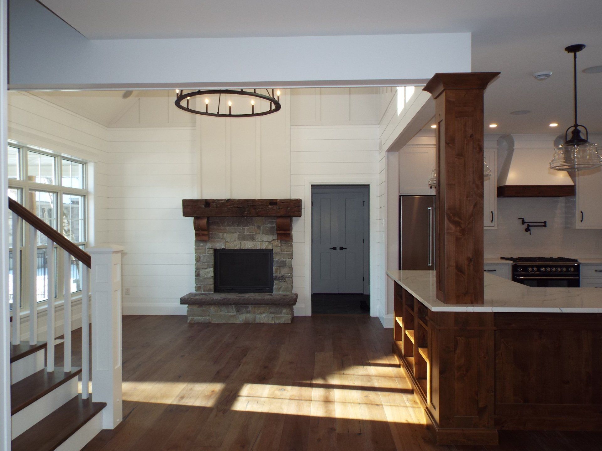 A living room with a fireplace and stairs leading to it