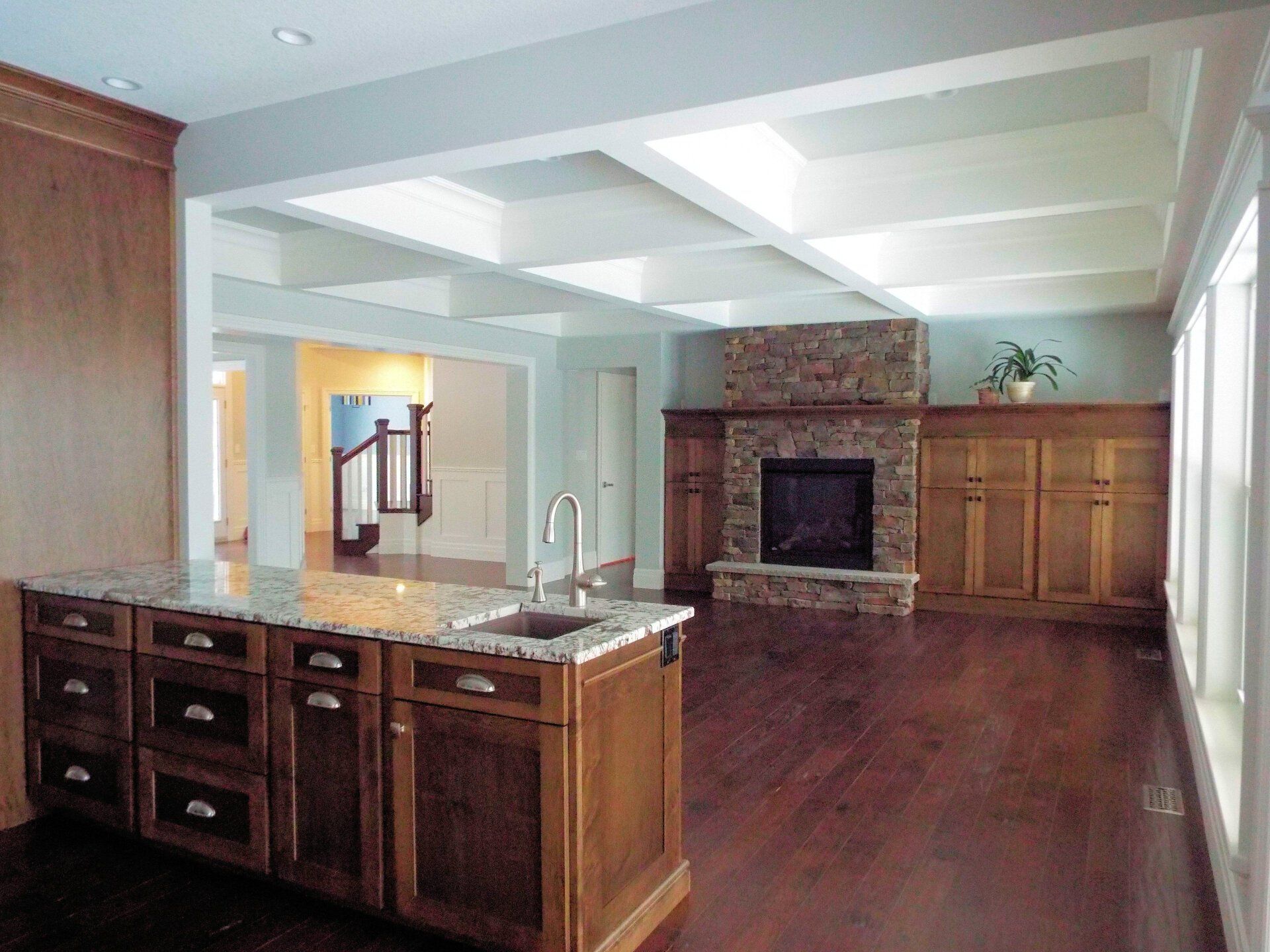 A kitchen with a large island and a fireplace