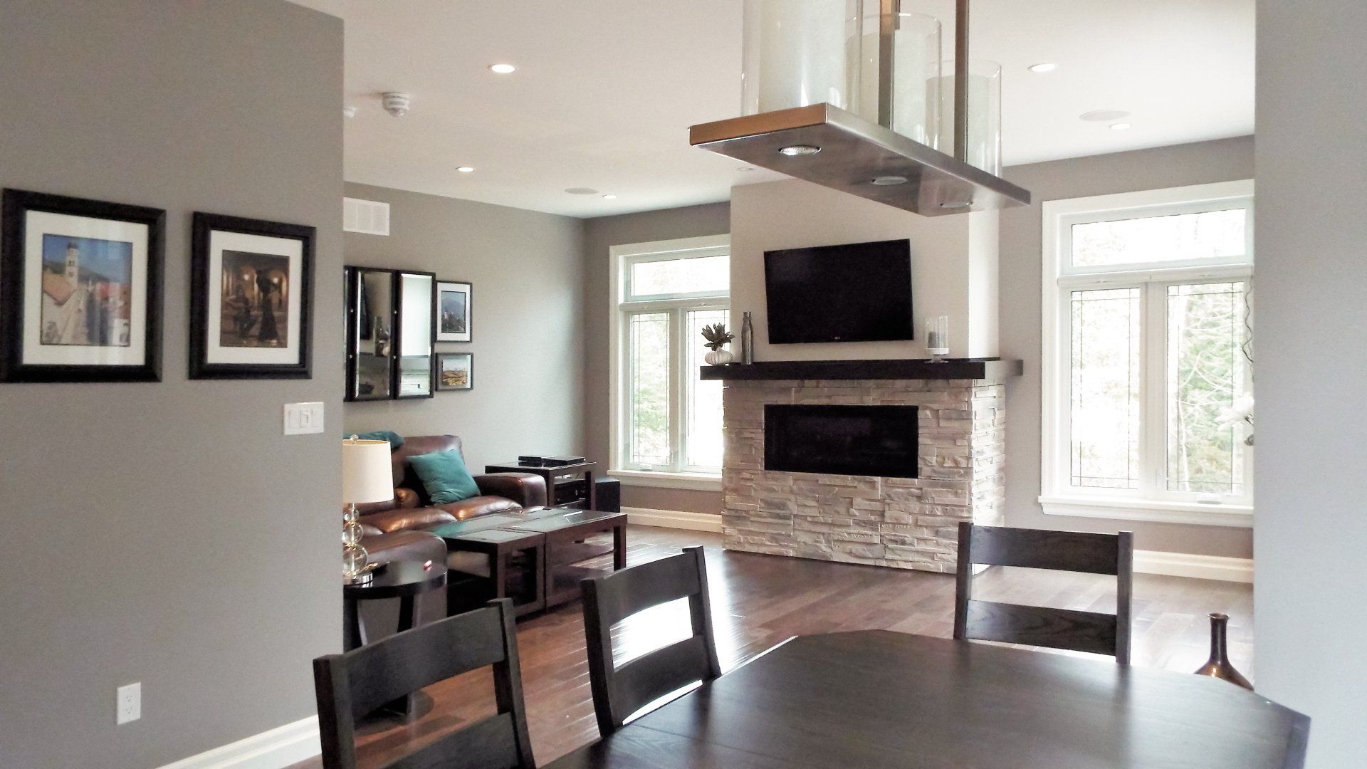 A living room with a table and chairs and a fireplace.