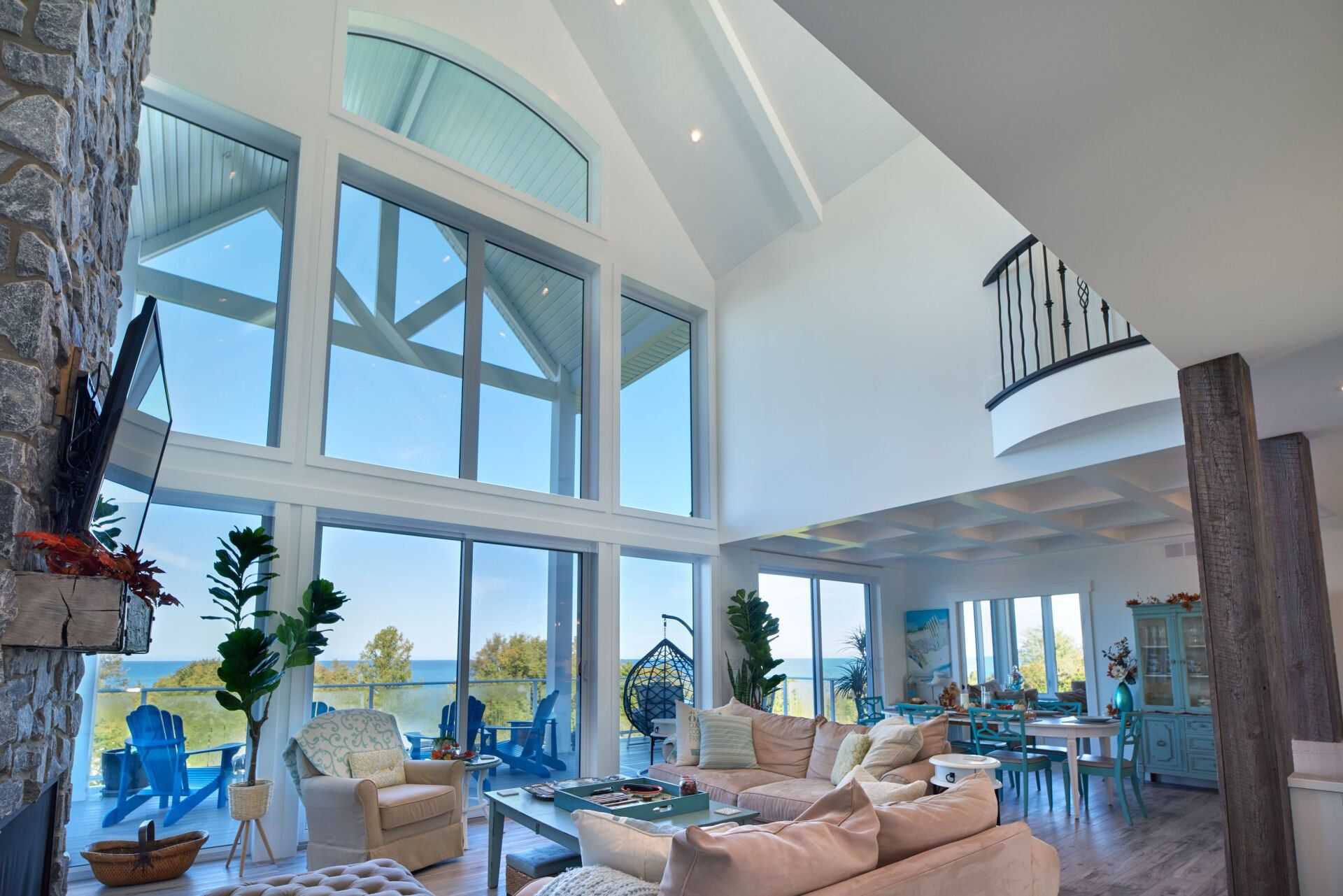 A living room with a lot of windows and a fireplace
