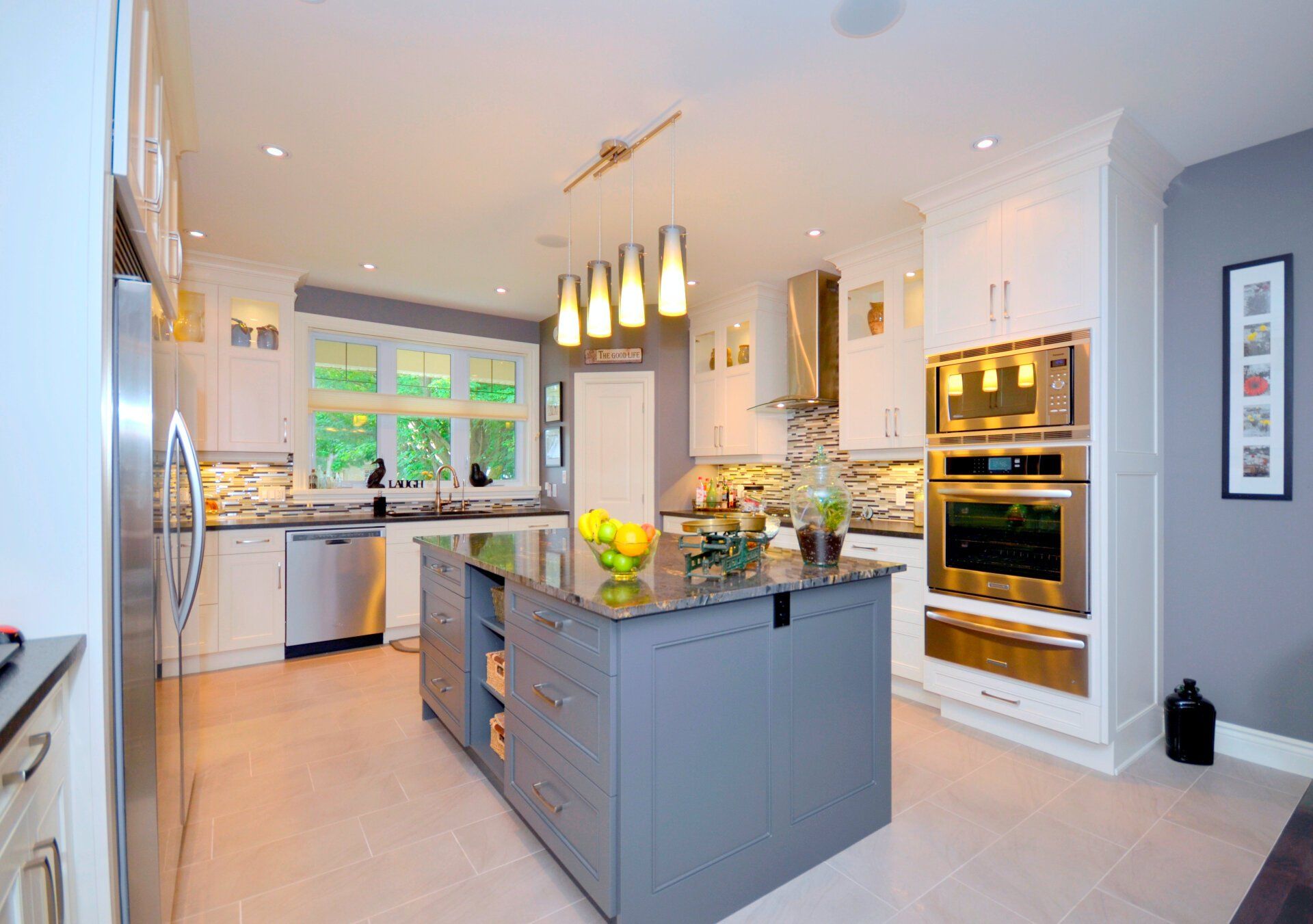 A kitchen with a large island and stainless steel appliances