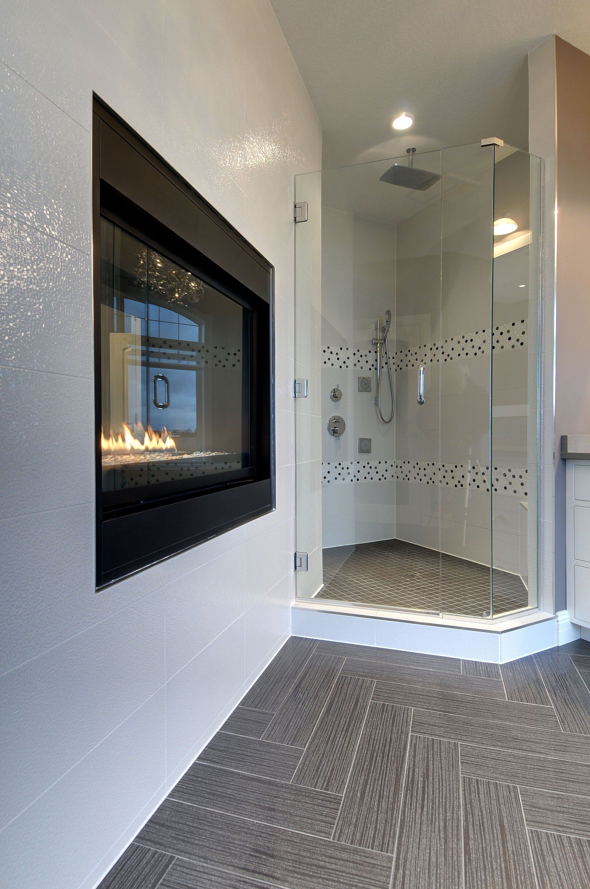 A bathroom with a fireplace and a walk in shower.