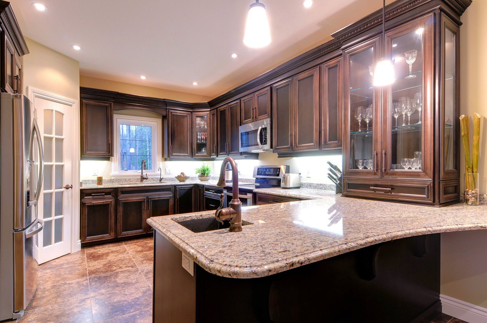 A kitchen with granite counter tops and stainless steel appliances