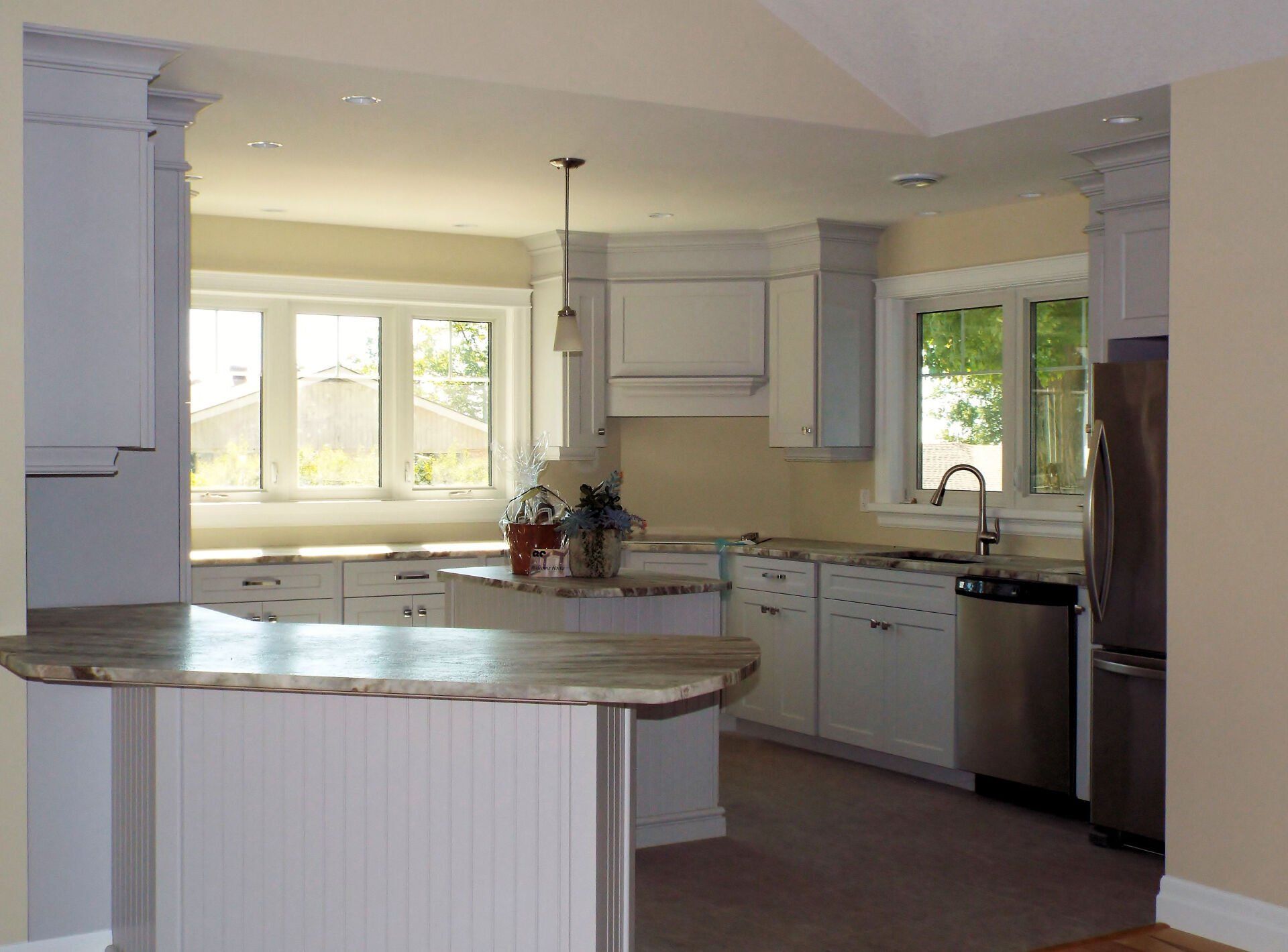 A kitchen with white cabinets and stainless steel appliances