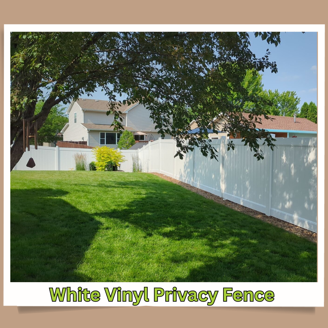 White vinyl privacy fence bordering a green backyard with trees and neighboring houses
