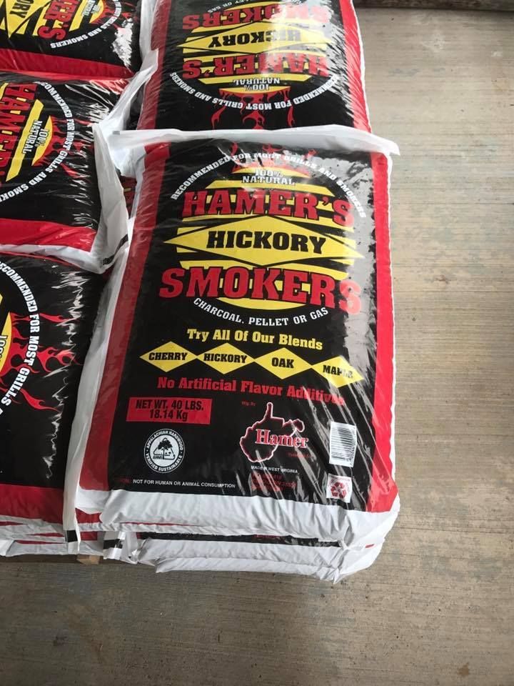 Bags of Ramsey's Hickory Smokers wood chips; black bags with red and yellow text, stacked.