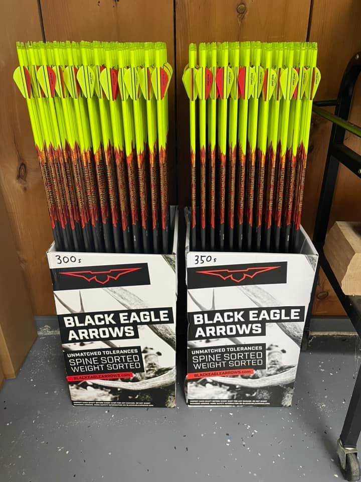 Two boxes of Black Eagle Arrows. Each box filled with neon yellow fletched arrows.