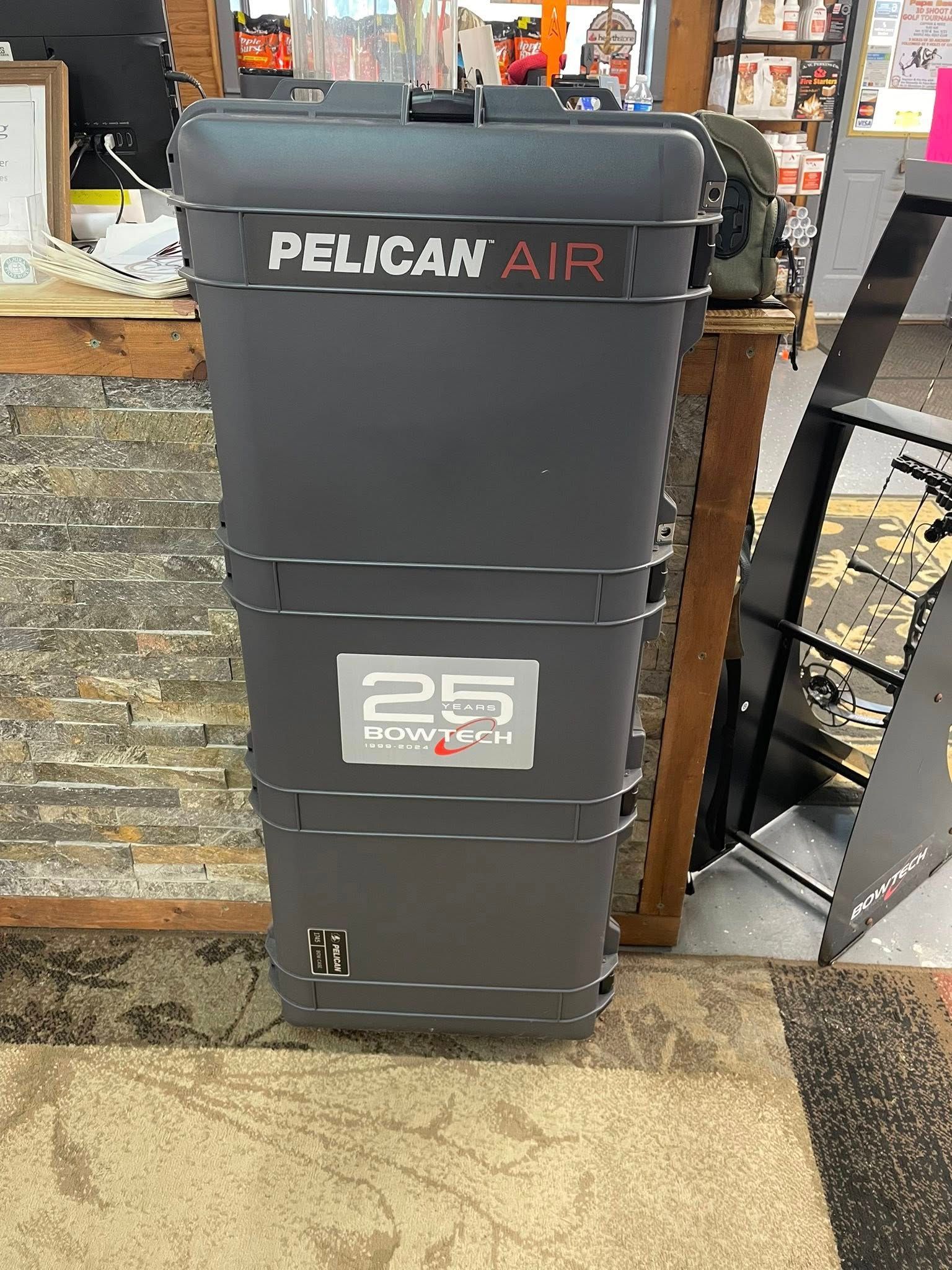 Dark gray Pelican Air 25 inch case on a rug inside a store.