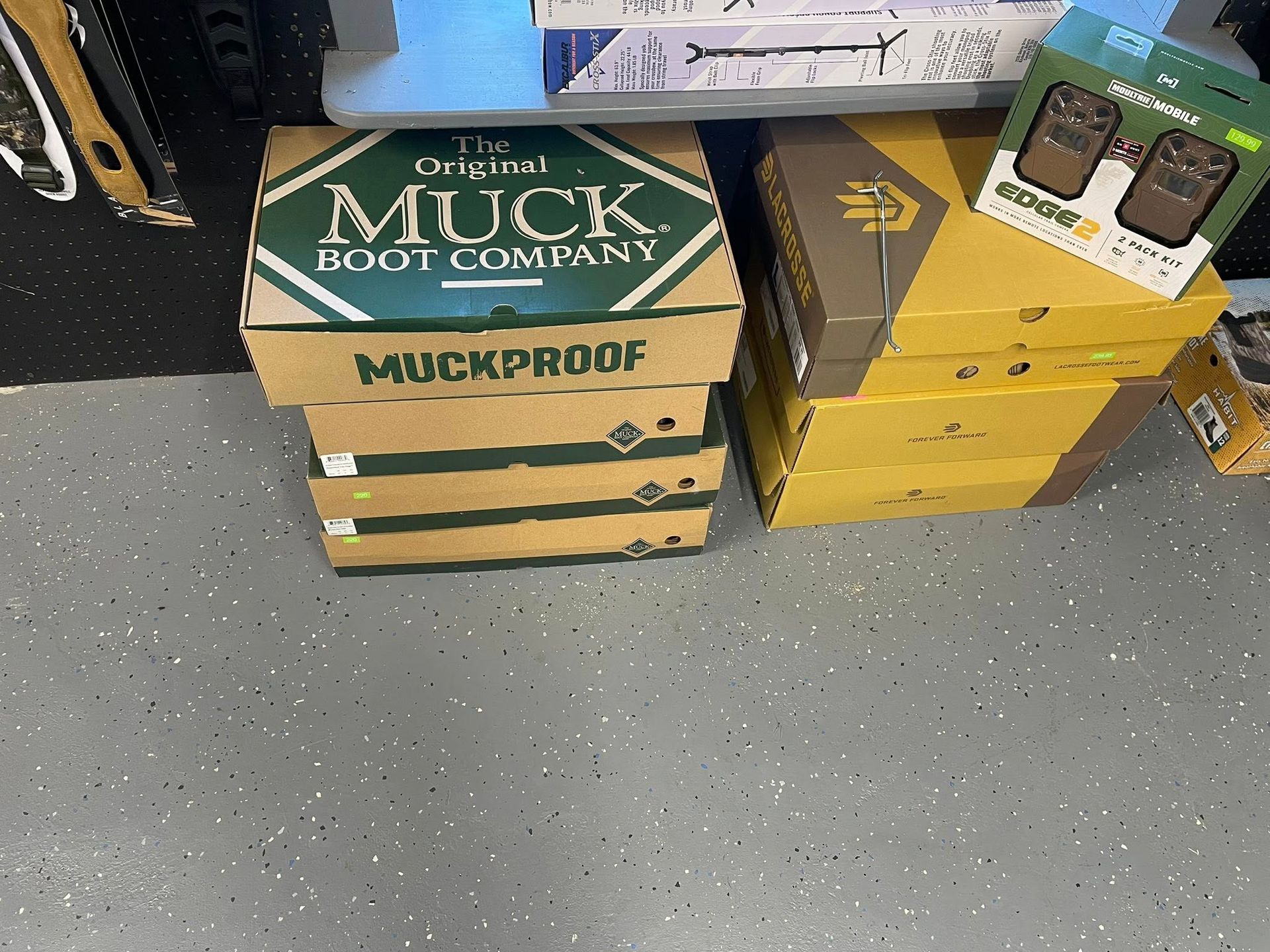Boxes stacked on a speckled gray floor: 