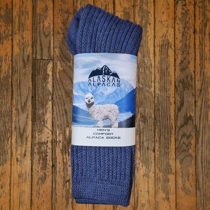 Blue alpaca socks with a label showing an alpaca in a snowy landscape.