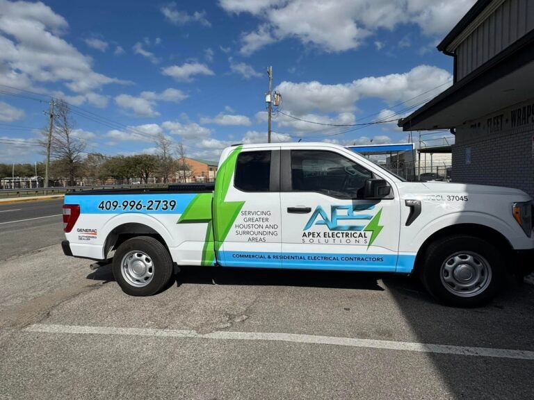 White Apex Electrical Solutions work truck parked outside, featuring a prominent green lightning bolt graphic on its side.