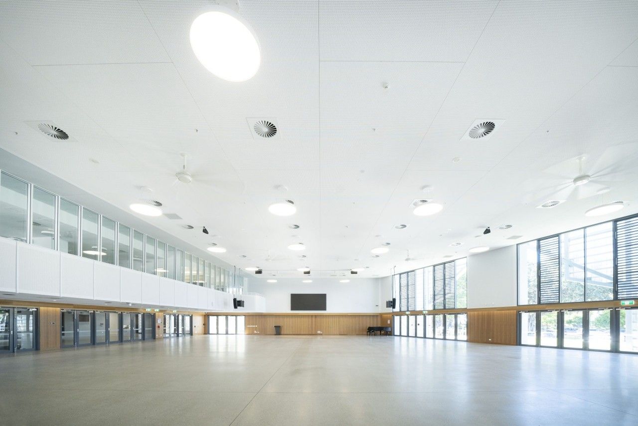 A Large Empty Room With a Lot of Windows and a Ceiling Light — Nick Favot Painting In Bohle, QLD