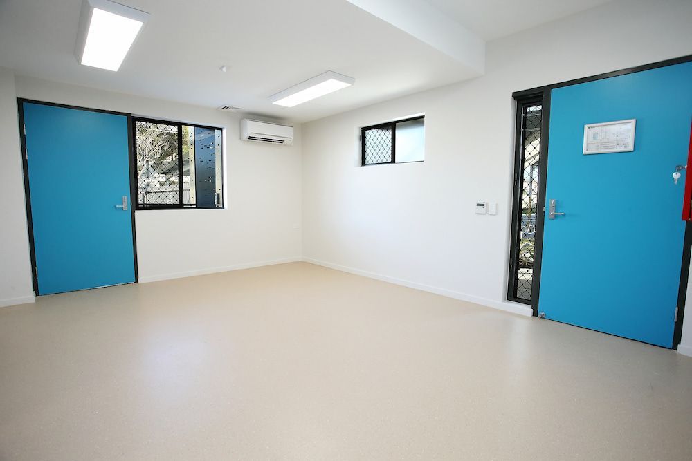 An Empty Room With Two Blue Doors and Two Windows — Nick Favot Painting in Bohle, QLD