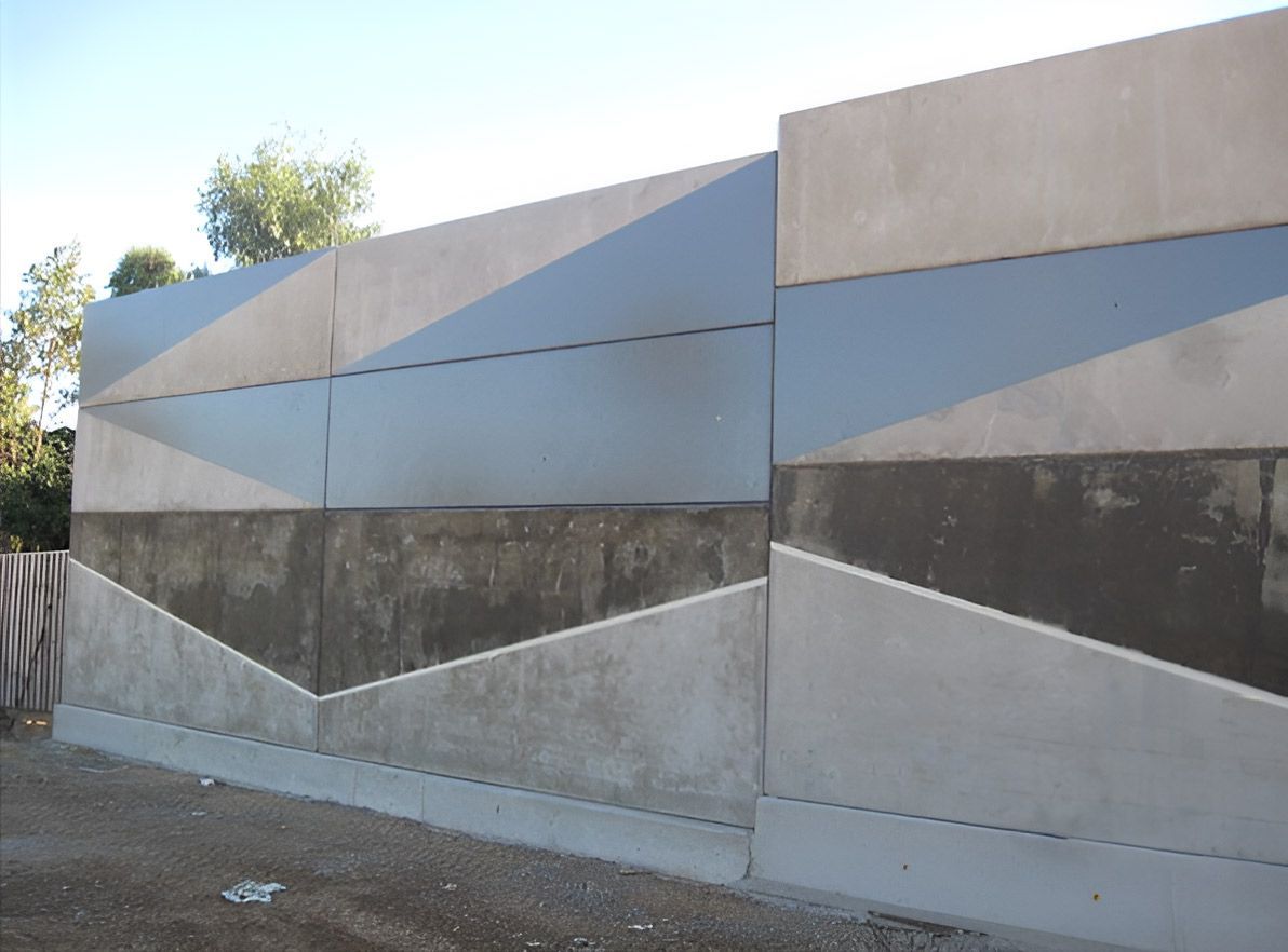 A Concrete Wall With a Geometric Design on It — Nick Favot Painting in Bohle, QLD
