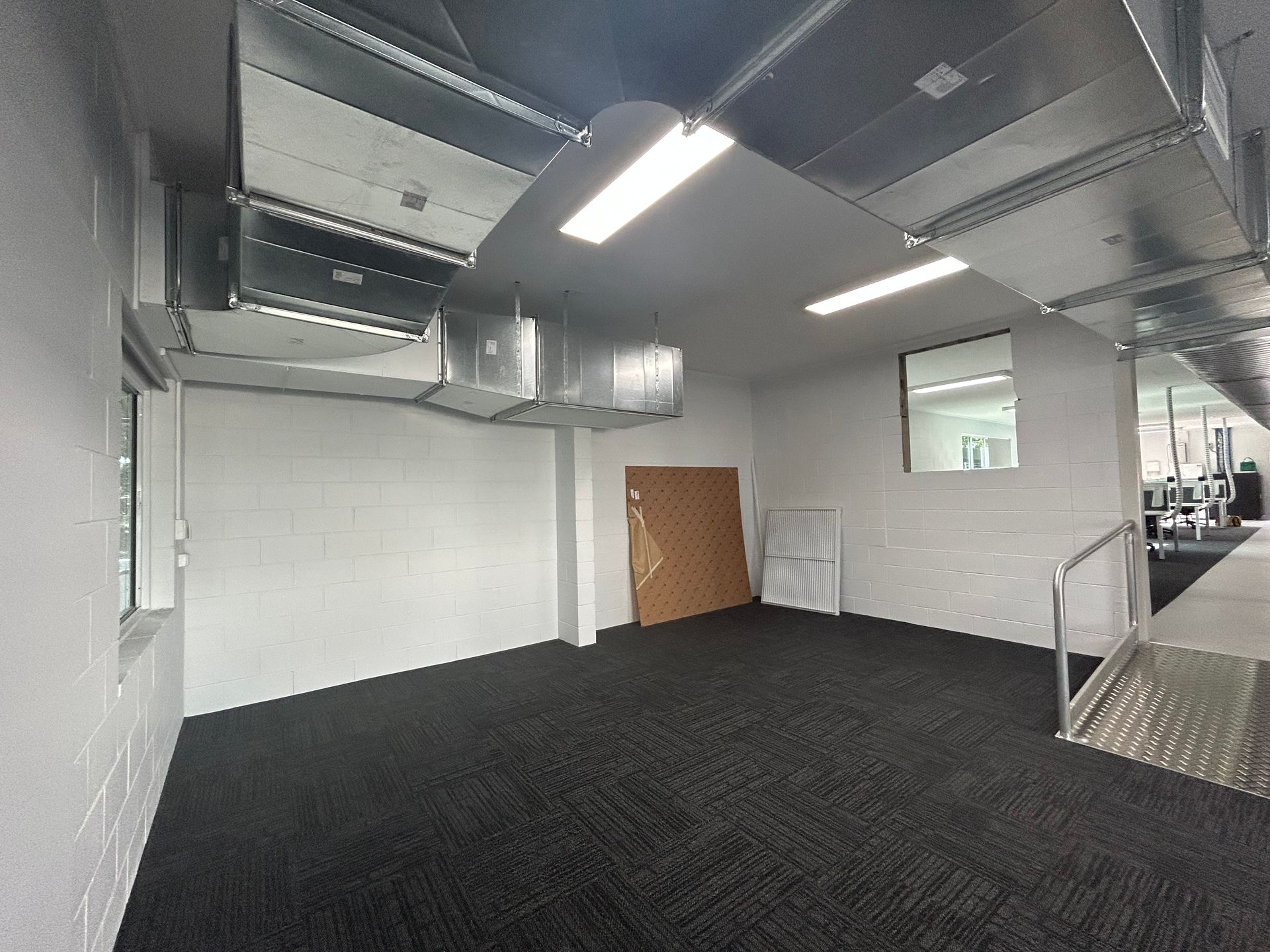 Empty Room Featuring Exposed Metallic Ductwork and Fluorescent Lighting — Nick Favot Painting In Bohle, QLD
