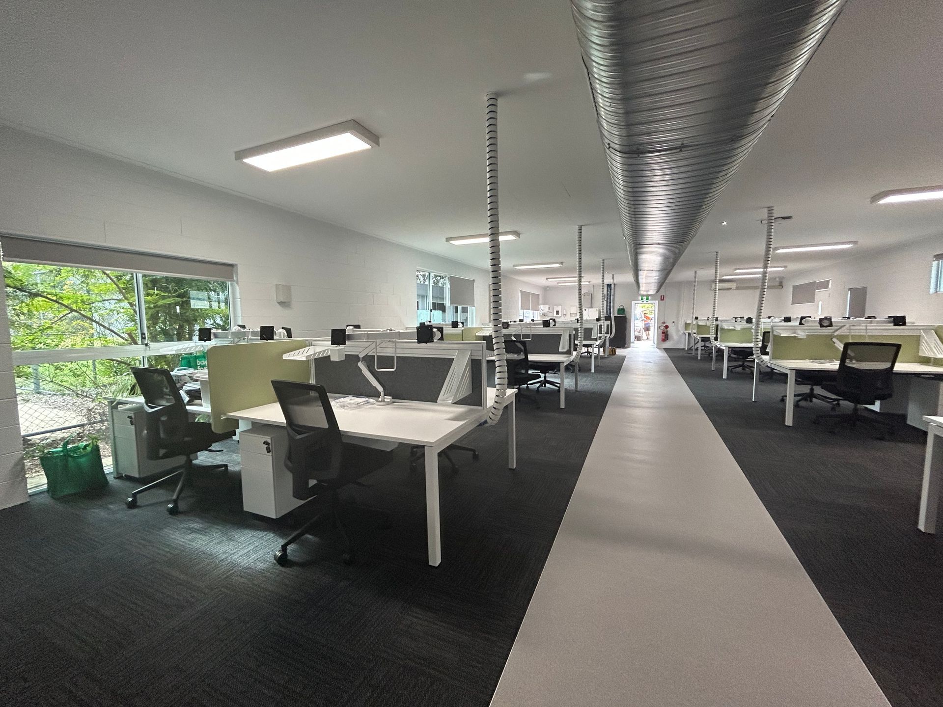 A Modern Office With Empty Workstations and Overhead Lighting — Nick Favot Painting In Bohle, QLD