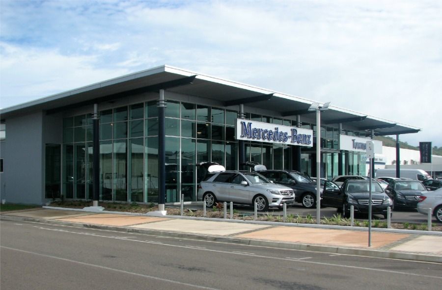 A Mercedes Benz Dealership With Cars Parked in Front of It — Nick Favot Painting in Bohle, QLD