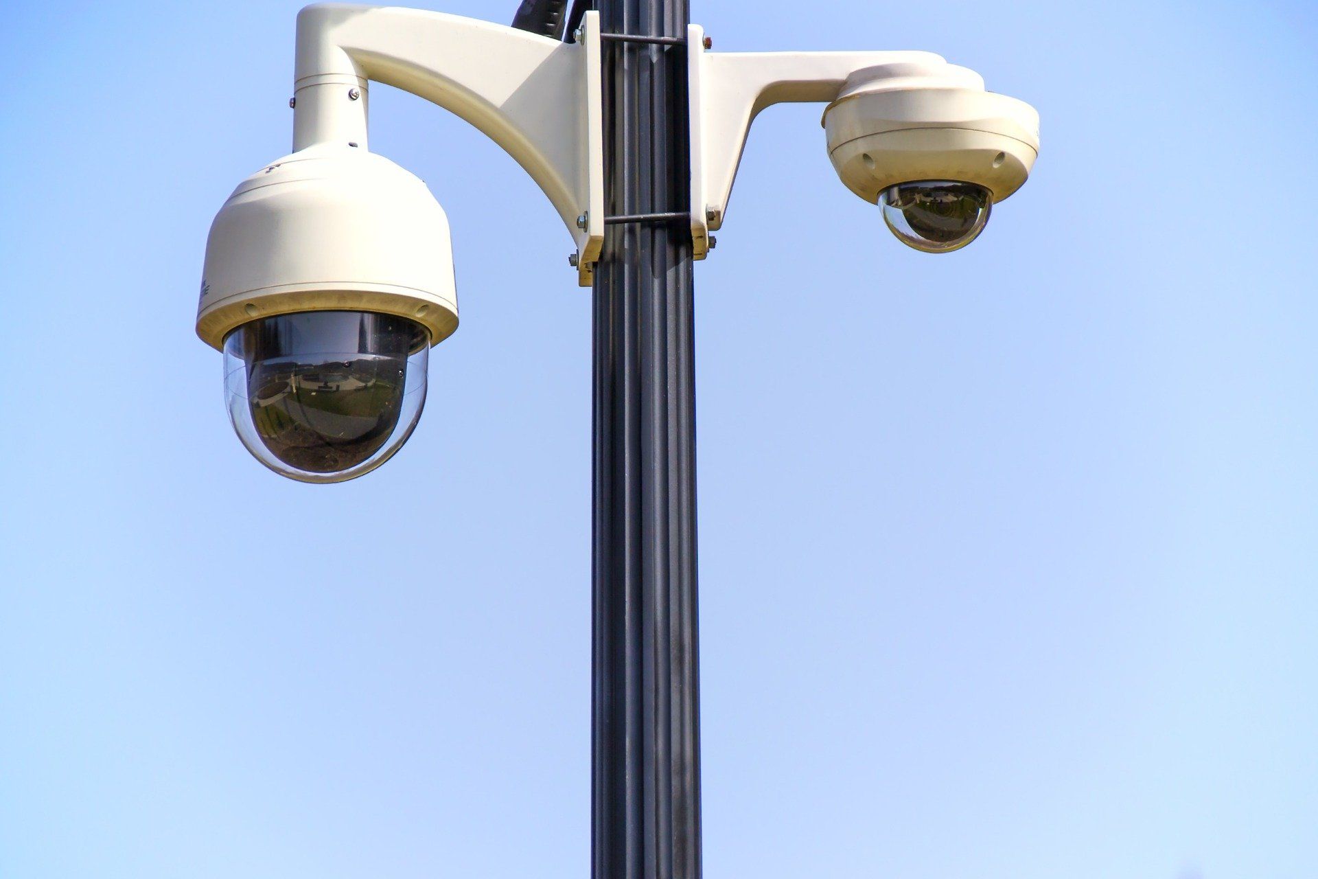 Install security cameras to protect your property dual security cameras mounted on a pole