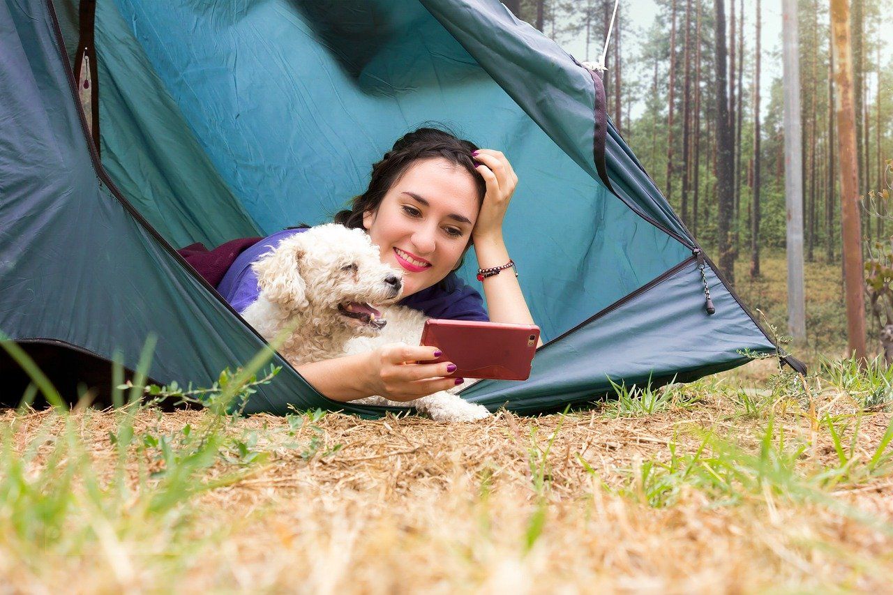 woman watching security cameras while camping