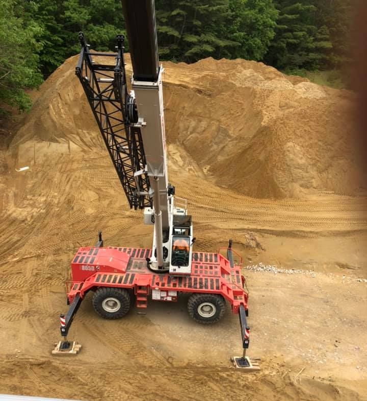 A Vermont Crane rental in use on a freshly excavated construction site