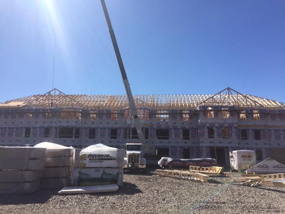 A Vermont crane rental lifts part of a new construction building's frame