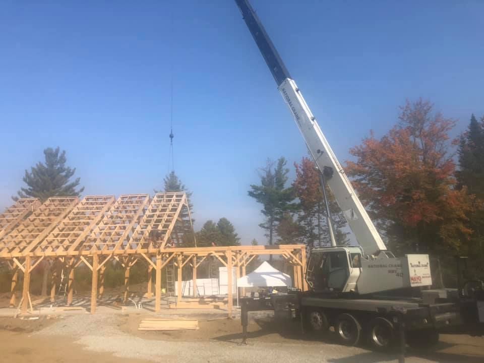 A new build's frame is constructed with the assistance of a crane truck from Mayo Crane Rental