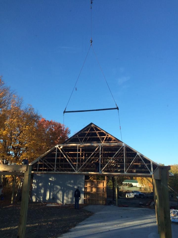 A Mayo Crane truck holds a building's frame in place during construction in Vermont