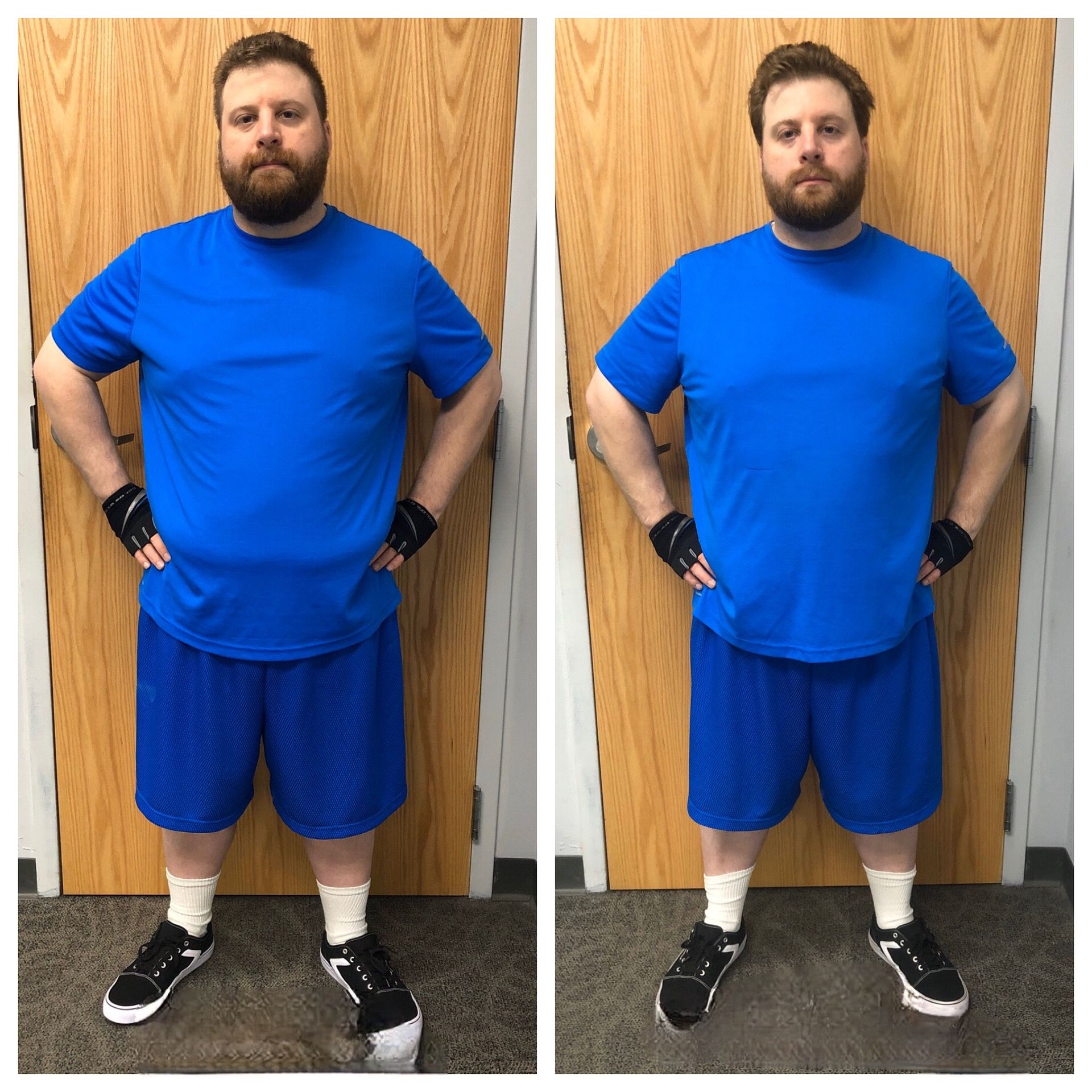 A man in a blue shirt and shorts is standing in front of a door.