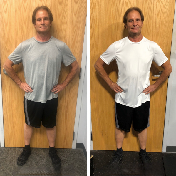 A man is standing in front of a door with his hands on his hips.