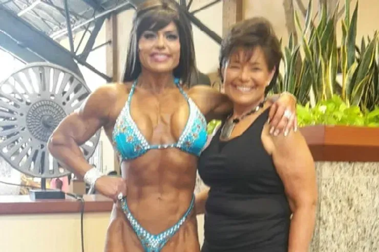 A woman in a bikini is posing for a picture with another woman.