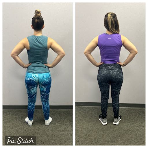 A woman is standing in front of a wall with her hands on her hips.