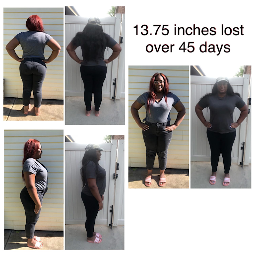 A woman is standing in front of a white fence with her hands on her hips.