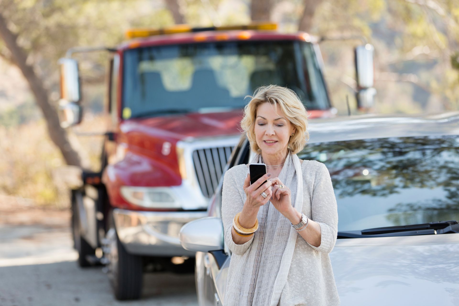Woman calling a help for roadside car breakdown