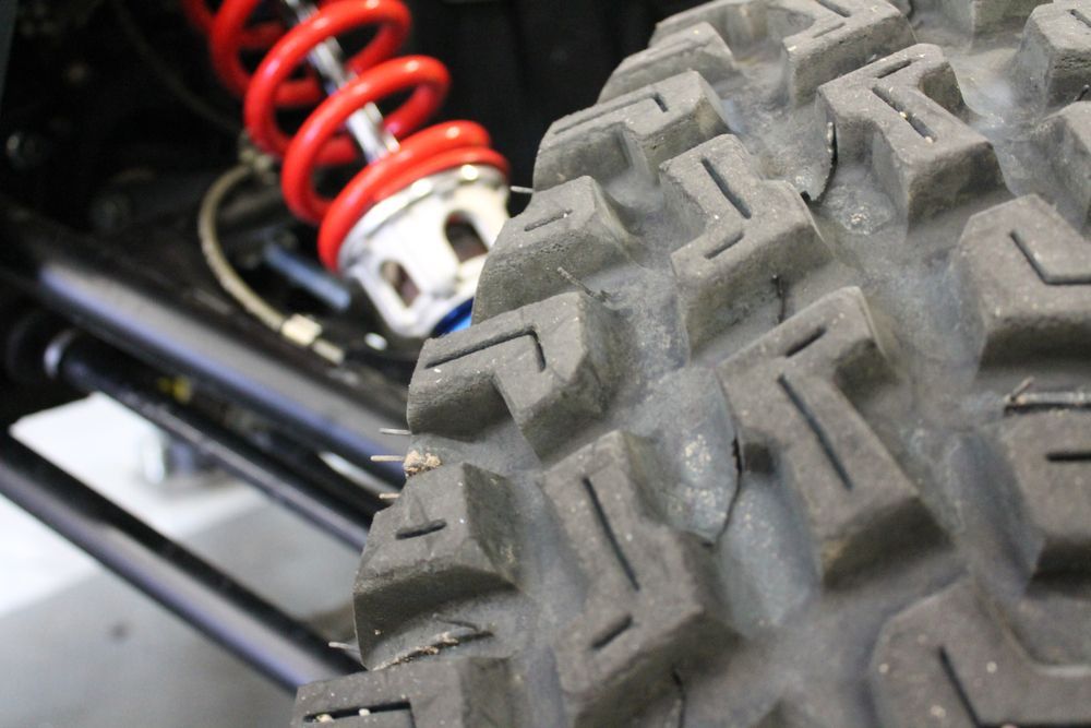 A Close Up of a Tire and Shock on a Vehicle — Westlakes 4x4 Centre in Maitland, NSW