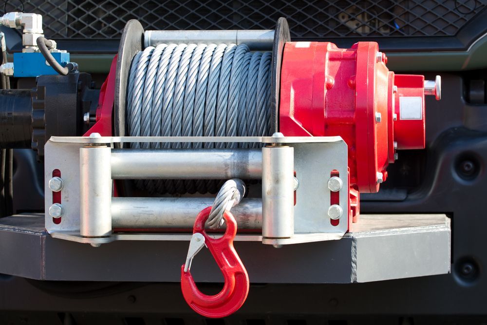 A Red Winch is Attached to the Front of a Truck — Westlakes 4x4 Centre in Maitland, NSW