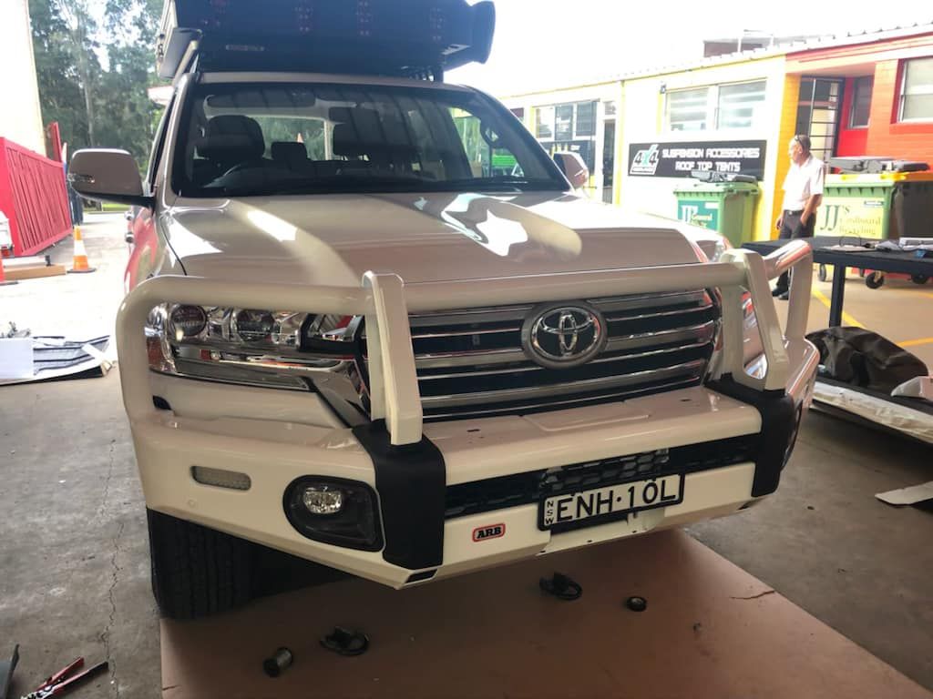 A White Toyota Land Cruiser is Parked in a Garage — Westlakes 4x4 Centre in Singleton, NSW