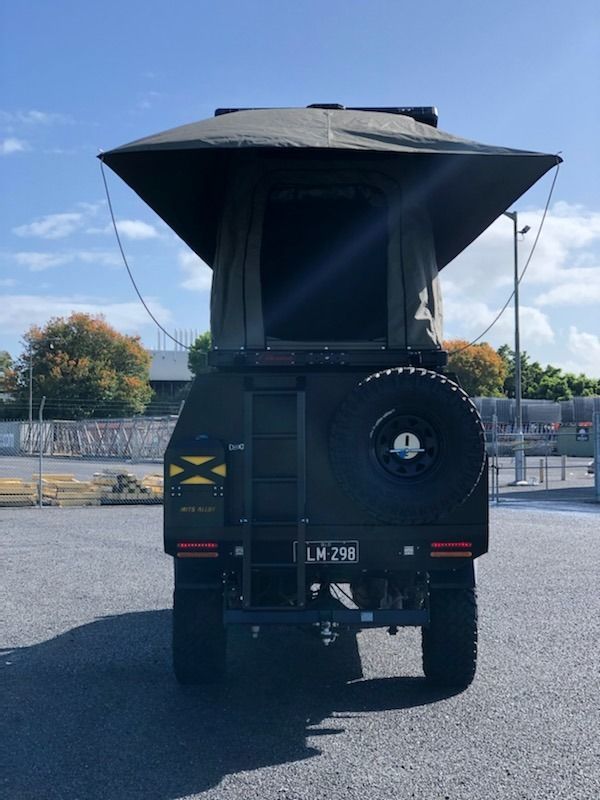 A Truck With a Tent on Top of It is Parked in a Parking Lot — Westlakes 4x4 Centre in Maitland, NSW