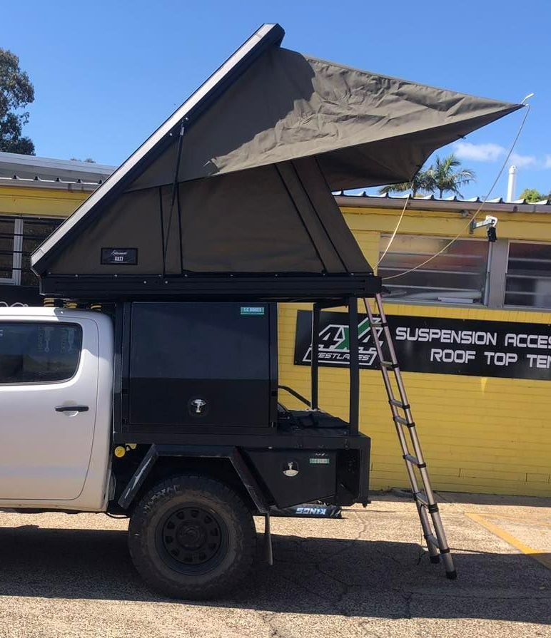 A White Truck With a Tent on Top of It — Westlakes 4x4 Centre in Singleton, NSW