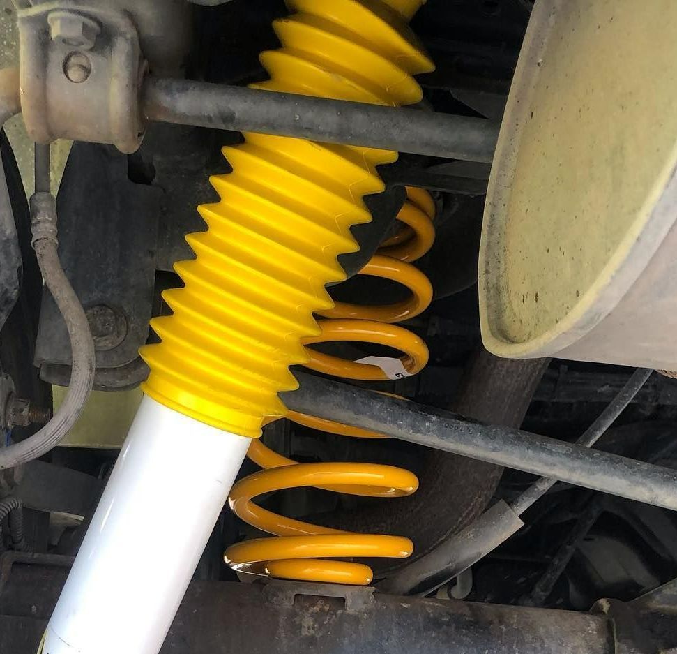 A Close Up of a Yellow Shock Absorber on a Car — Westlakes 4x4 Centre in Maitland, NSW