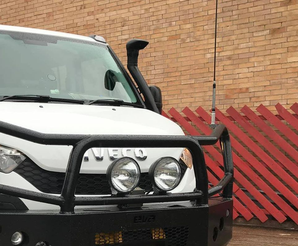 A White Iveco Truck is Parked in Front of a Red Fence — Westlakes 4x4 Centre in Maitland, NSW