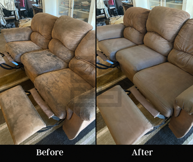 Cleaner vacuuming a beige sofa in a bright living room with a handheld upholstery tool