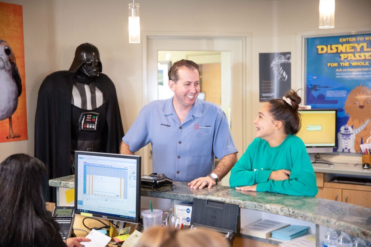 Darth Vader beside a man and woman talking at a counter in a kitchen showroom
