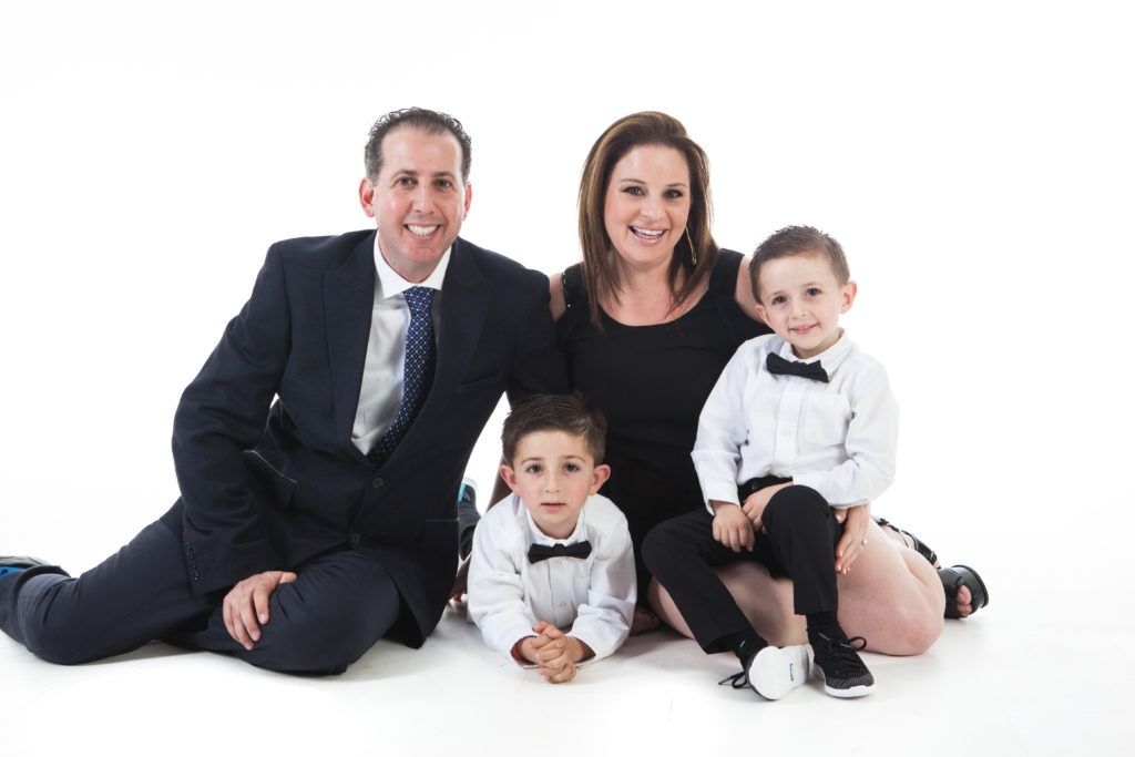 Dr. Charles Brodsky with his wife Vicky and sons Jack and Blake in a formal family portrait